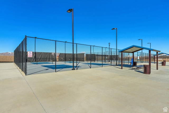 view of tennis court with fence