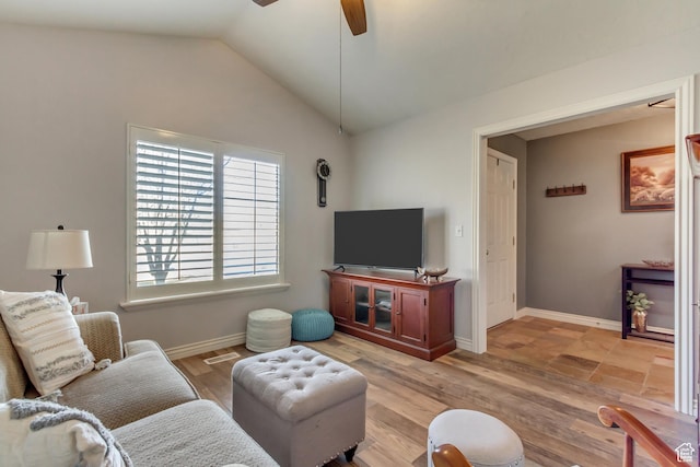 living area with lofted ceiling, light wood finished floors, a ceiling fan, and baseboards
