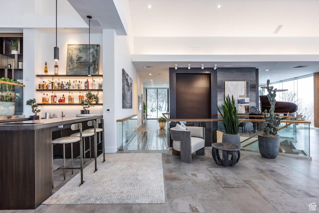 3826 E Thousand Oaks Cir, Salt Lake City, UT 84124 - bar featuring a bar, a wall of windows, and decorative light fixtures