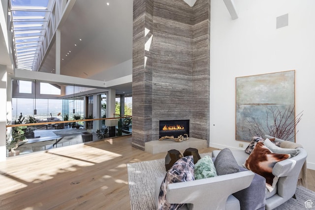 3826 E Thousand Oaks Cir, Salt Lake City, UT 84124 - living area with a towering ceiling, a fireplace, visible vents, and wood finished floors