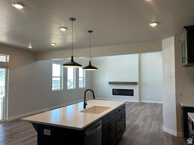 1552 N Cozy Ln Unit 05, Saratoga Springs, UT 84045 - kitchen featuring a sink, dishwasher, a textured ceiling, dark wood-type flooring, and light countertops