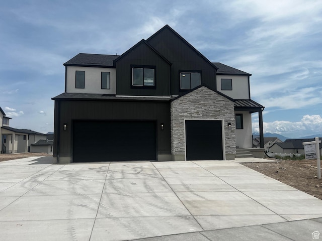 1552 N Cozy Ln Unit 05, Saratoga Springs, UT 84045 - view of front of home featuring stone siding, driveway, a garage, and a standing seam roof
