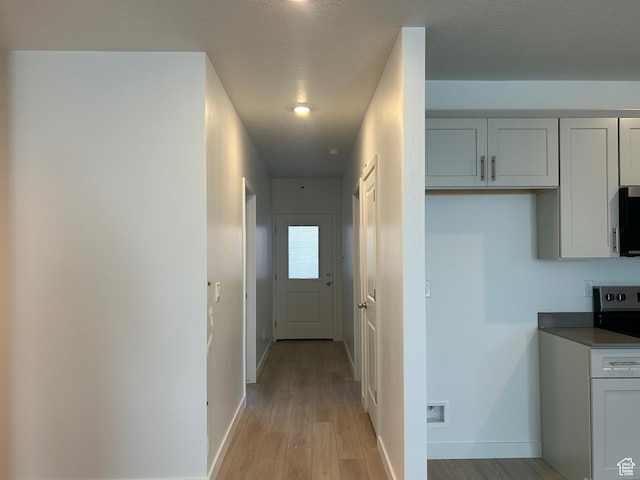 1552 N Cozy Ln Unit 05, Saratoga Springs, UT 84045 - corridor with light wood finished floors and baseboards