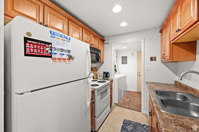 kitchen with light tile patterned flooring, white appliances, a sink, electric panel, and washing machine and clothes dryer