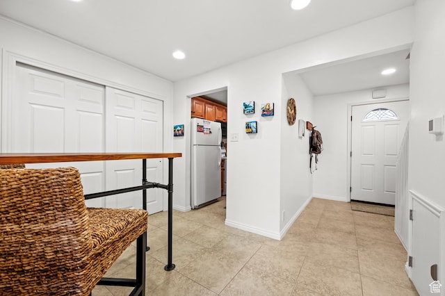 interior space with light tile patterned floors, baseboards, and recessed lighting