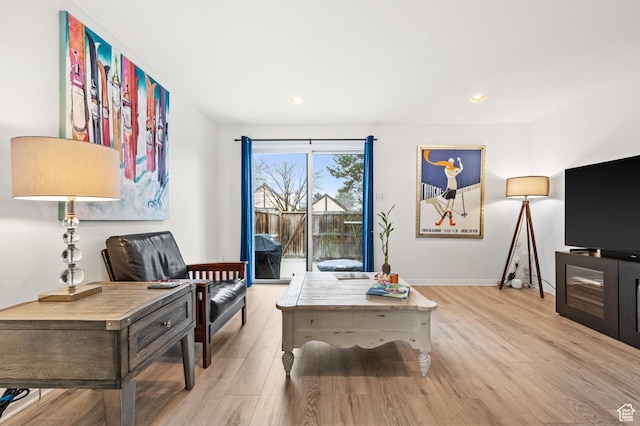 living area with light wood-style flooring, baseboards, and recessed lighting