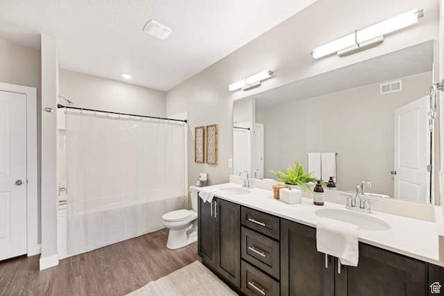 2101 N Main St W Unit 302, Sunset, UT 84015 - full bath featuring visible vents, toilet, wood finished floors, shower / tub combo with curtain, and a sink