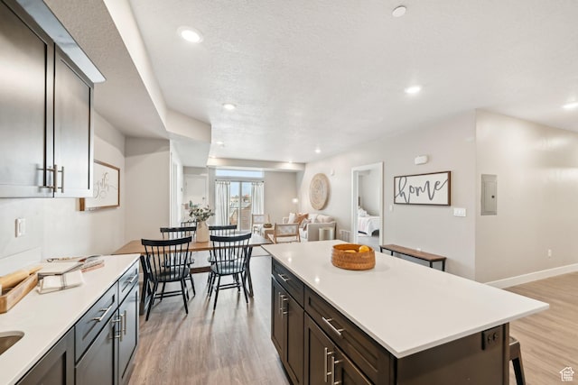2101 N Main St W Unit 302, Sunset, UT 84015 - kitchen with recessed lighting, a kitchen island, light wood-style floors, open floor plan, and light countertops