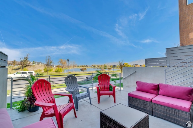 view of patio with a water view and an outdoor living space
