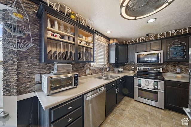 204 W Crescent View Ln N Unit 111, Tooele, UT 84074 - kitchen featuring a toaster, stainless steel appliances, light countertops, backsplash, and a sink
