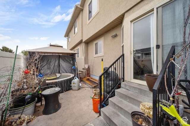 204 W Crescent View Ln N Unit 111, Tooele, UT 84074 - view of patio with entry steps, fence, and a gazebo
