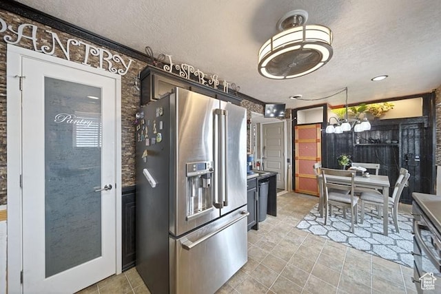 204 W Crescent View Ln N Unit 111, Tooele, UT 84074 - kitchen featuring light tile patterned floors, high end refrigerator, an inviting chandelier, a textured ceiling, and pendant lighting