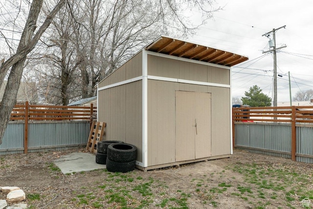 view of shed with a fenced backyard