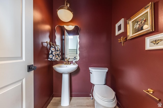 4623 N Festival Way, Eagle Mountain, UT 84005 - bathroom with wood finished floors, toilet, baseboards, and a sink