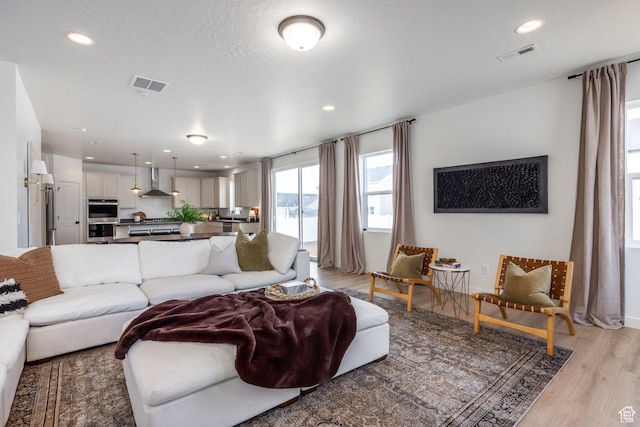 4623 N Festival Way, Eagle Mountain, UT 84005 - living room featuring recessed lighting, light wood-type flooring, and visible vents