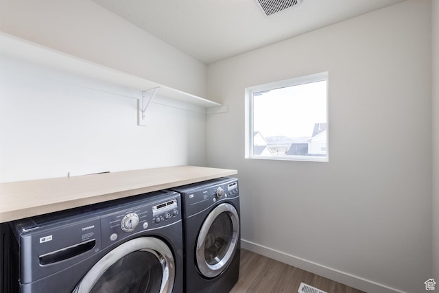4623 N Festival Way, Eagle Mountain, UT 84005 - laundry area with washing machine and clothes dryer, baseboards, visible vents, wood finished floors, and laundry area