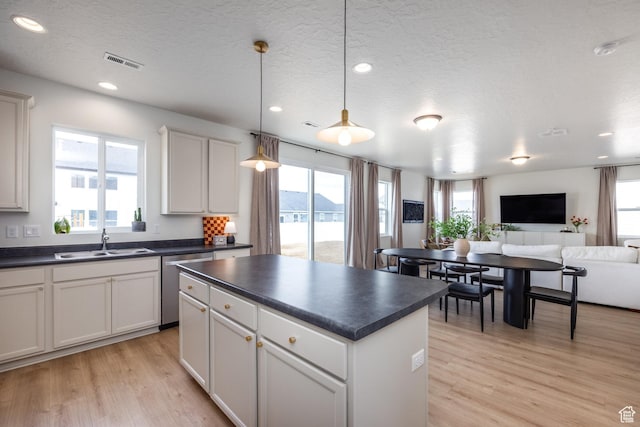 4623 N Festival Way, Eagle Mountain, UT 84005 - kitchen featuring dark countertops, visible vents, stainless steel dishwasher, and a sink
