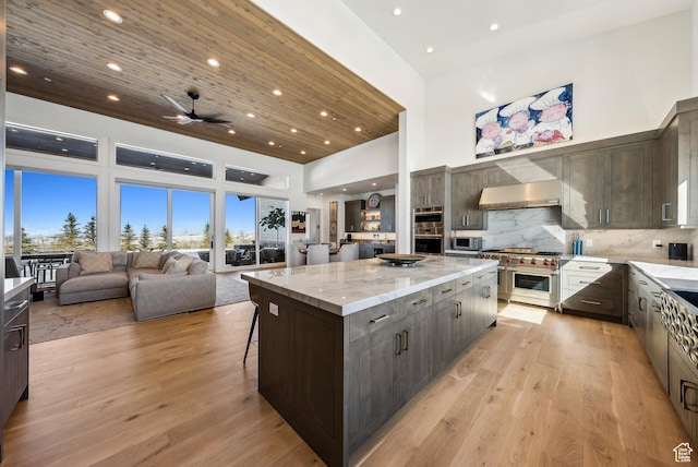 9279 E Aspen Rd, Heber City, UT 84032 - kitchen featuring a spacious island, wood ceiling, open floor plan, wall chimney range hood, and high vaulted ceiling