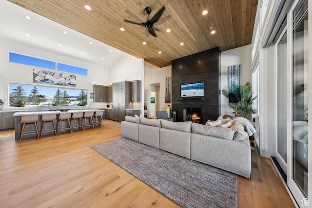 9279 E Aspen Rd, Heber City, UT 84032 - living area with recessed lighting, a large fireplace, a ceiling fan, light wood-style floors, and high vaulted ceiling