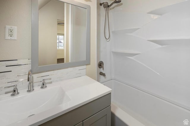 57 S Main St, Smithfield, UT 84335 - full bathroom with vanity, decorative backsplash, and bathing tub / shower combination