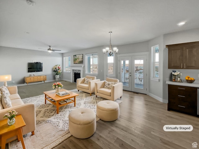 456 E 3675 N, North Ogden, UT 84414 - living area featuring baseboards, french doors, light wood-type flooring, a fireplace, and a notable chandelier