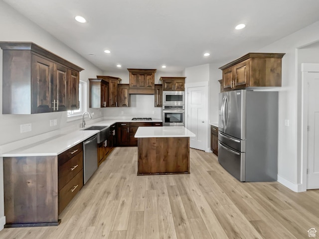 456 E 3675 N, North Ogden, UT 84414 - kitchen featuring dark brown cabinetry, light wood finished floors, appliances with stainless steel finishes, a center island, and light countertops