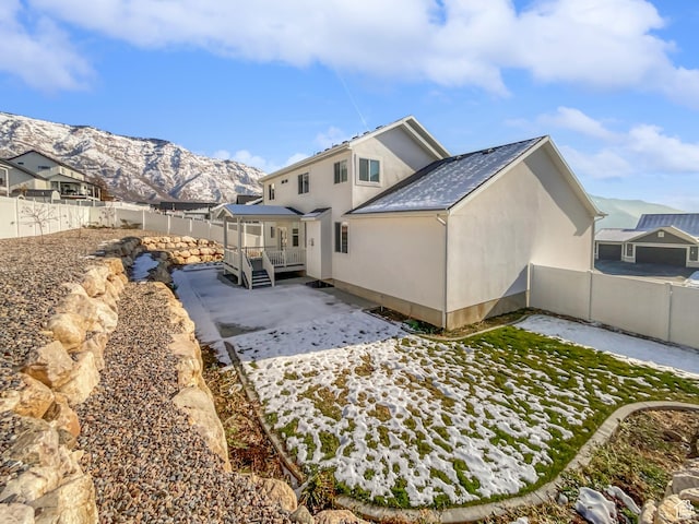 456 E 3675 N, North Ogden, UT 84414 - back of house featuring a fenced backyard, a mountain view, a patio, and stucco siding