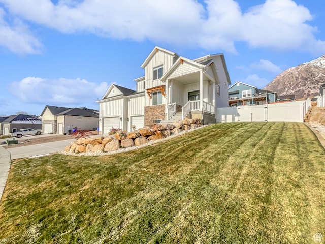 456 E 3675 N, North Ogden, UT 84414 - view of front of home featuring a residential view, fence, a mountain view, a front lawn, and board and batten siding