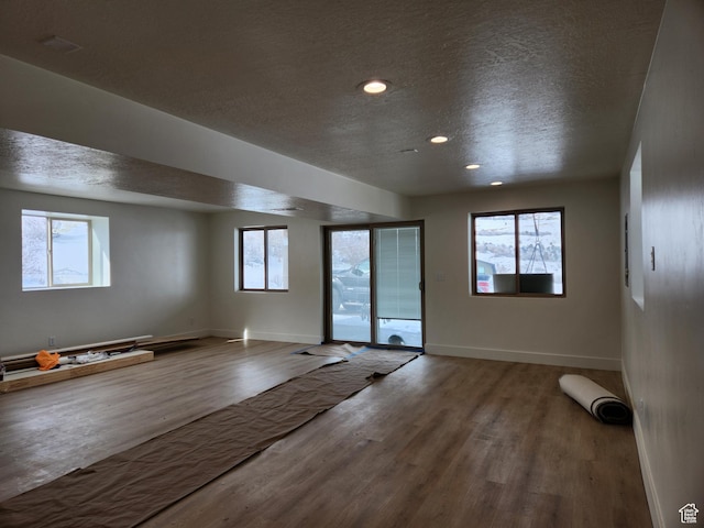 1538 N Mackinaw Way, Garden City, UT 84028 - interior space with a textured ceiling, wood finished floors, and a healthy amount of sunlight