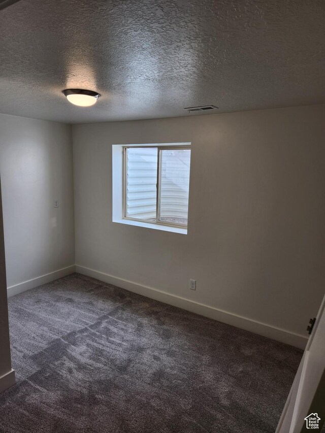 1538 N Mackinaw Way, Garden City, UT 84028 - carpeted spare room with visible vents, a textured ceiling, and baseboards