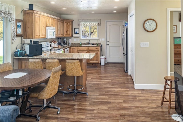 275 W 60 S, Hyde Park, UT 84318 - kitchen featuring white appliances, dark wood finished floors, a peninsula, a sink, and recessed lighting
