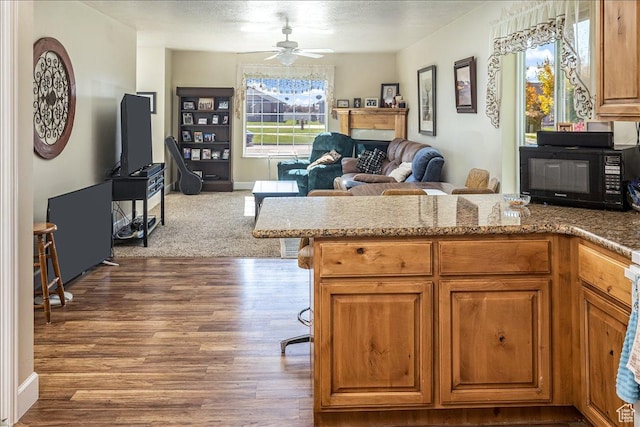 275 W 60 S, Hyde Park, UT 84318 - kitchen with brown cabinetry, open floor plan, wood finished floors, black microwave, and a peninsula
