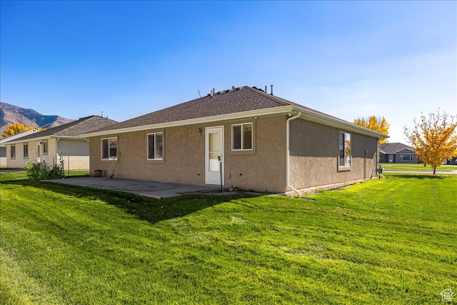 275 W 60 S, Hyde Park, UT 84318 - back of house featuring a yard, a shingled roof, a patio, and stucco siding