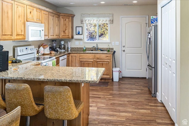 275 W 60 S, Hyde Park, UT 84318 - kitchen with light stone counters, dark wood-style flooring, a sink, white appliances, and a peninsula