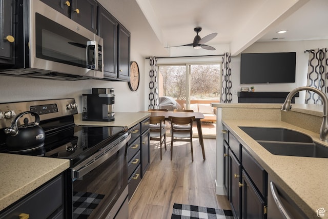 3246 E Fairway Loop, Moab, UT 84532 - kitchen with light wood-type flooring, recessed lighting, appliances with stainless steel finishes, a ceiling fan, and a sink