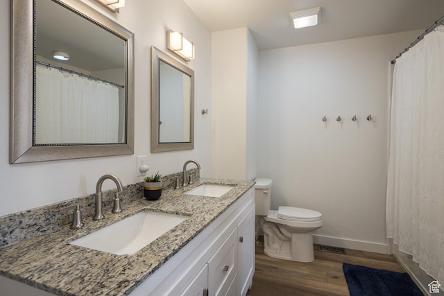 3246 E Fairway Loop, Moab, UT 84532 - full bath with toilet, wood finished floors, baseboards, and a sink