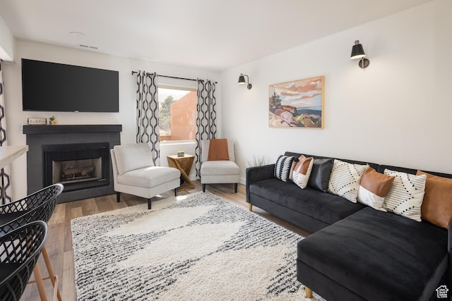 3246 E Fairway Loop, Moab, UT 84532 - living room with visible vents, a fireplace, and wood finished floors