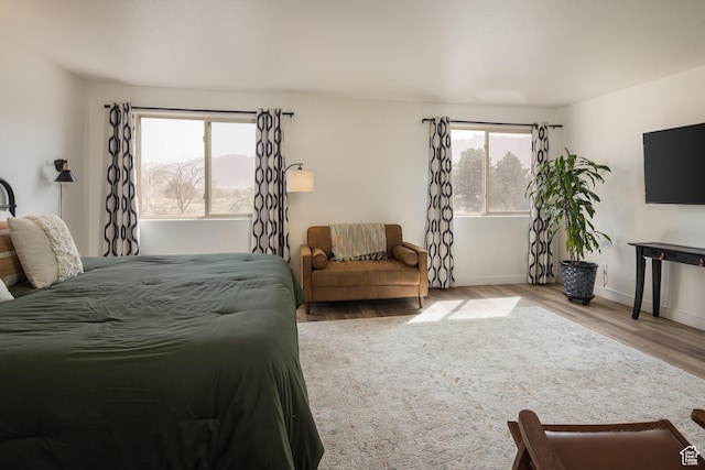 3246 E Fairway Loop, Moab, UT 84532 - bedroom with baseboards, multiple windows, and wood finished floors