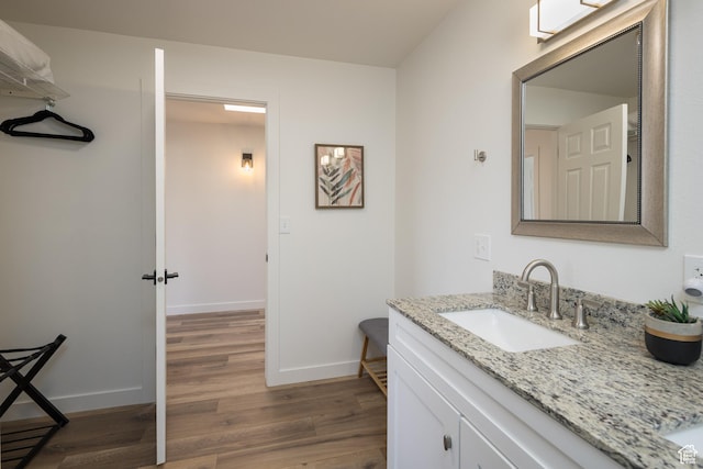 3246 E Fairway Loop, Moab, UT 84532 - bathroom with vanity, wood finished floors, and baseboards