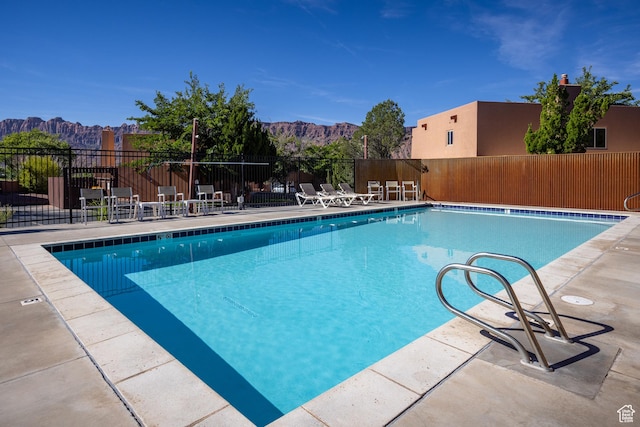 3246 E Fairway Loop, Moab, UT 84532 - pool with a mountain view, a patio, and fence