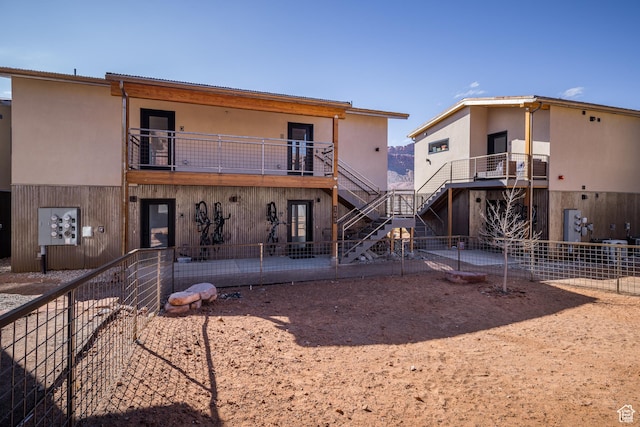 1185 S Murphy Ln Unit 105A, Moab, UT 84532 - back of property featuring a balcony, stairway, fence, and a patio