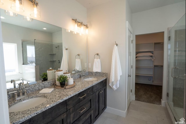 3966 W 2025 S, Taylor, UT 84401 - bathroom with a stall shower, tile patterned flooring, a spacious closet, and a sink