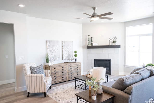 3966 W 2025 S, Taylor, UT 84401 - living area with recessed lighting, a tiled fireplace, ceiling fan, wood finished floors, and baseboards