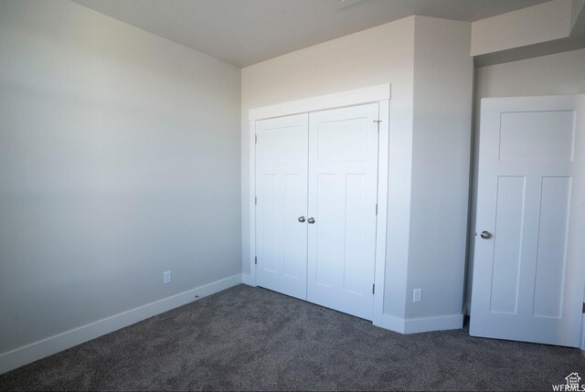 3966 W 2025 S, Taylor, UT 84401 - unfurnished bedroom featuring a closet, dark carpet, and baseboards