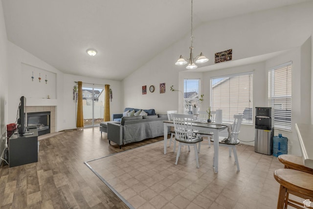 8282 S 6430 W, West Jordan, UT 84081 - dining room with high vaulted ceiling, wood finished floors, a wealth of natural light, and a tile fireplace