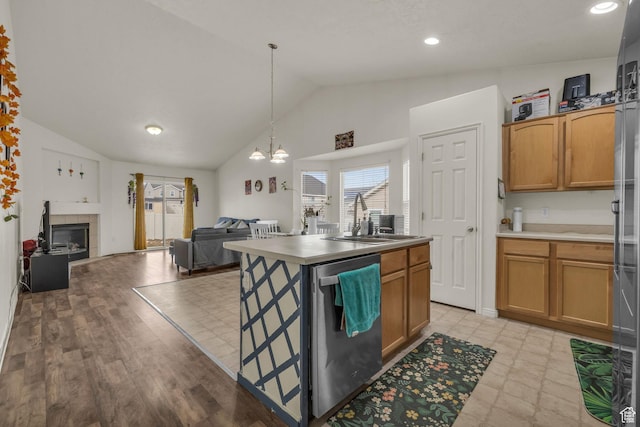 8282 S 6430 W, West Jordan, UT 84081 - kitchen featuring a sink, vaulted ceiling, open floor plan, dishwasher, and a tiled fireplace