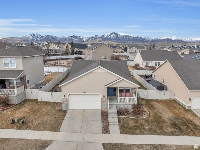 8282 S 6430 W, West Jordan, UT 84081 - view of front of home featuring a gate, a residential view, a mountain view, and concrete driveway