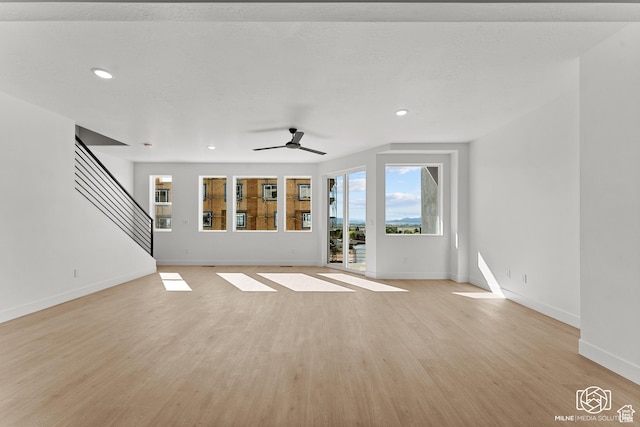 665 E 2015 N # 5E, Cedar City, UT 84721 - unfurnished living room with baseboards, a ceiling fan, light wood-style flooring, stairway, and recessed lighting