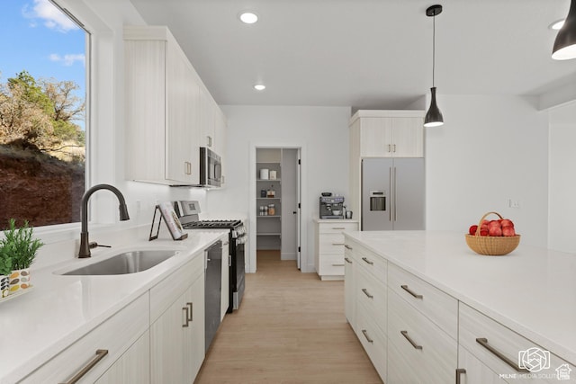 665 E 2015 N # 5E, Cedar City, UT 84721 - kitchen featuring stainless steel appliances, a sink, light wood-style floors, light countertops, and decorative light fixtures
