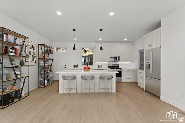 665 E 2015 N # 5E, Cedar City, UT 84721 - kitchen featuring stainless steel appliances, a kitchen island, white cabinetry, light countertops, and light wood-type flooring